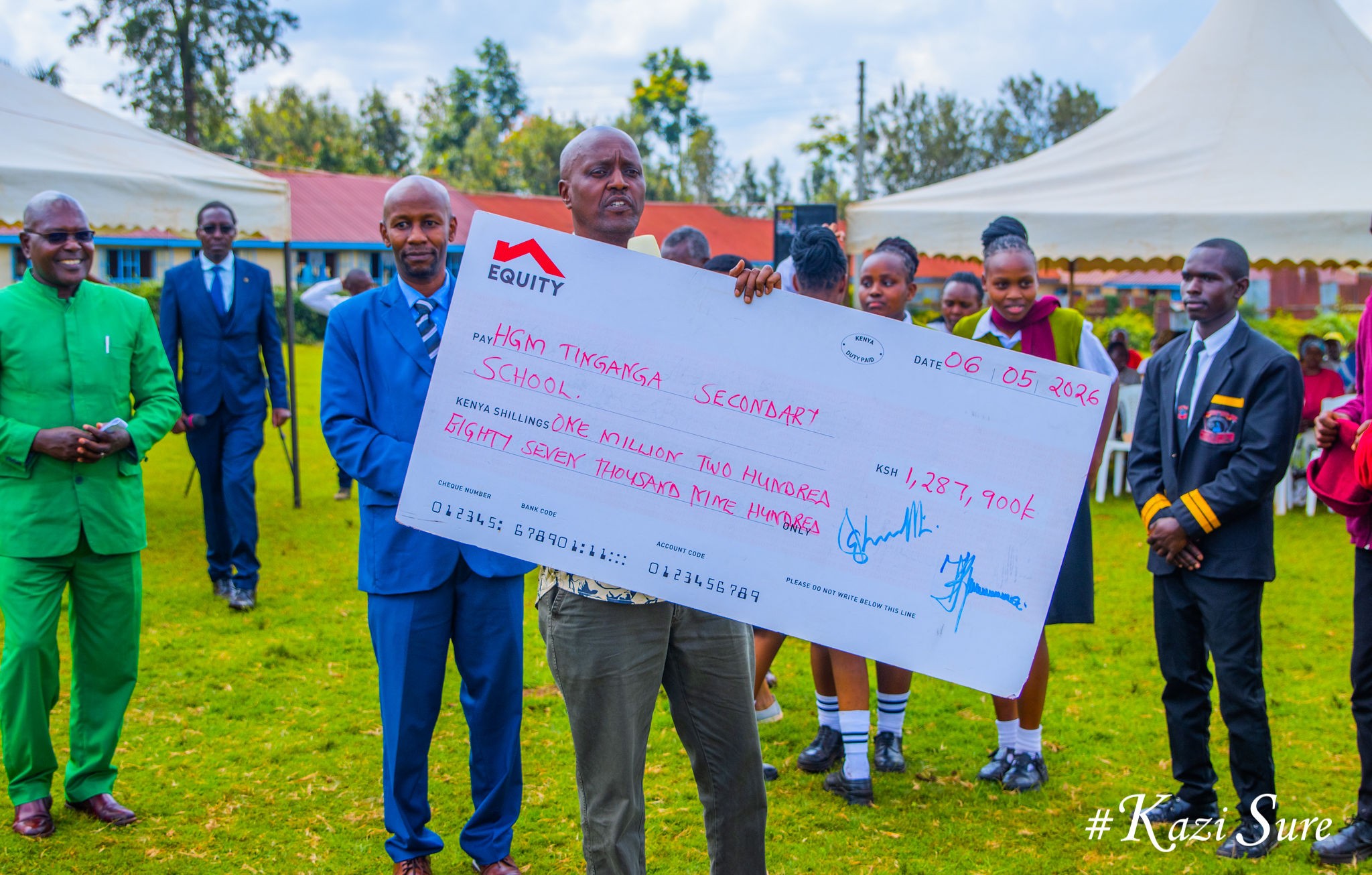 MP holding the bursary cheque
